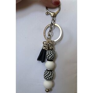 Elegant Black and White Keychain with Gold Accents